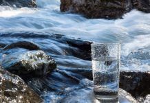 water flowing behind glass of water