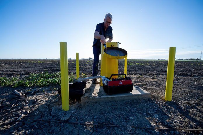DWR engineering geologist measures groundwater levels